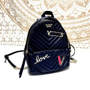 Victoria’s Secret black mini backpack. Golden accents. Pockets. Excellent cond